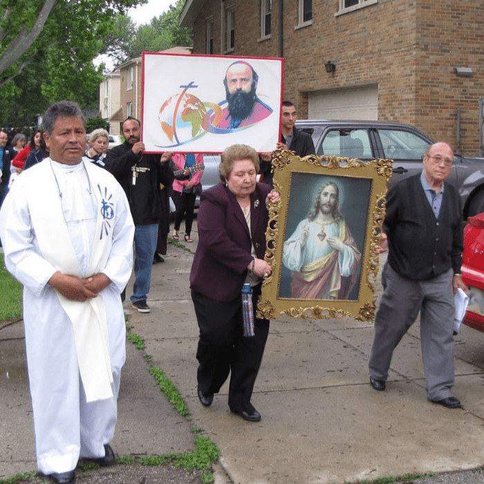 Comboni Missionary priest and parishioners in outdoor procession